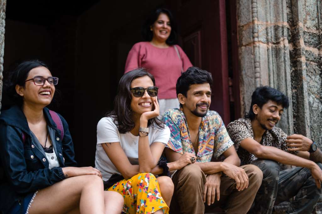 Travellers exploring a vibrant marketplace with Make It Happen